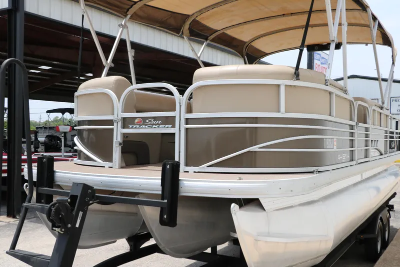 Slide: The Image of 2020 Sun Tracker SportFish 22 XP3 pontoon boat with canopy, docked outdoors. - 7