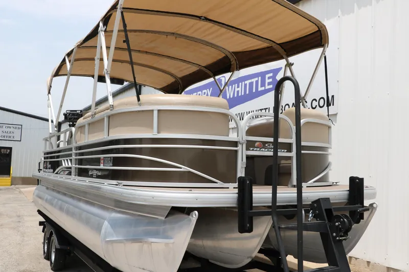 Slide: The Image of 2020 Sun Tracker SportFish 22 XP3 pontoon boat with canopy, parked on a trailer. - 9