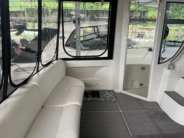 Slide: The Image of 2005 Carver 46 Motor Yacht interior with white seating and large windows. - 10