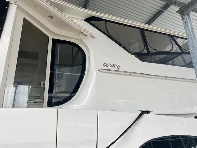 Slide: The Image of 2005 Carver 46 Motor Yacht, side view under a covered dock. - 11