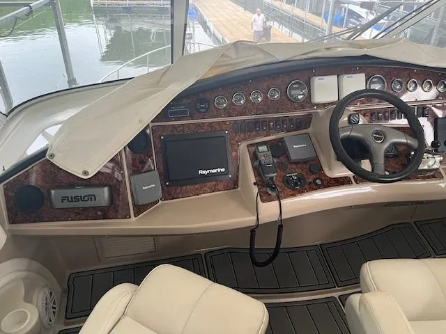 Slide: The Image of 2005 Carver 46 Motor Yacht helm with navigation equipment and luxurious seating. - 13