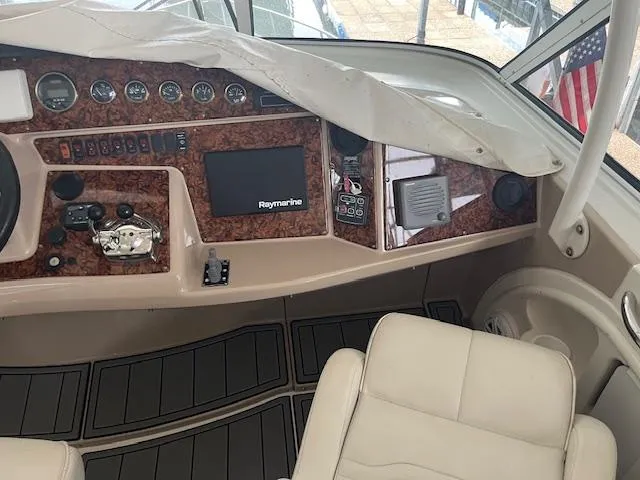 Slide: The Image of 2005 Carver 46 Motor Yacht helm with Raymarine navigation system and leather seating. - 15