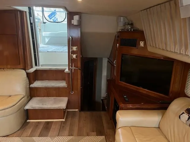 Slide: The Image of Interior of 2005 Carver 46 Motor Yacht with stairs, seating, and TV. - 16