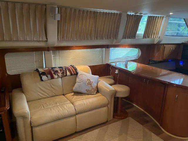 Slide: The Image of Interior of 2005 Carver 46 Motor Yacht with beige sofa and wooden cabinetry. - 19