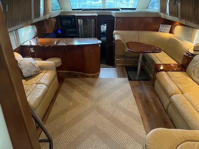 Slide: The Image of Luxurious interior of a 2005 Carver 46 Motor Yacht with plush seating and elegant wood finishes. - 21