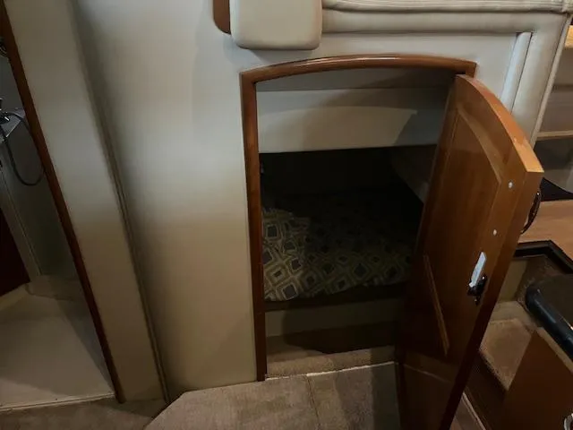 Slide: The Image of 2005 Carver 46 Motor Yacht interior with open wooden door revealing cozy cabin space. - 24