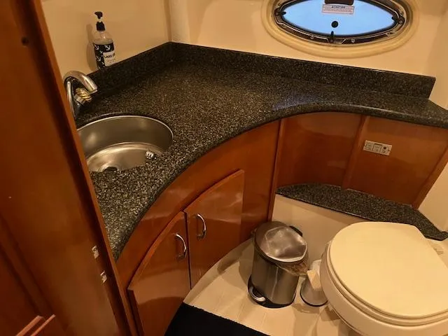 Slide: The Image of 2005 Carver 46 Motor Yacht bathroom with granite countertop and stainless steel sink. - 26