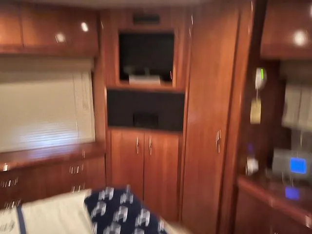 Slide: The Image of Interior of 2005 Carver 46 Motor Yacht with wood cabinetry and built-in TV. - 28