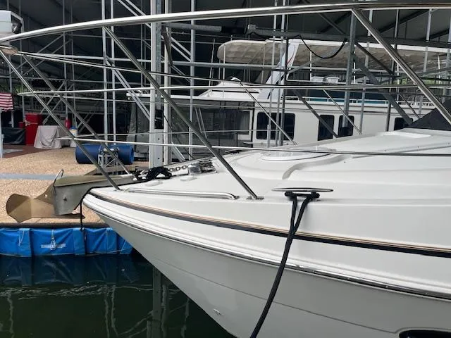 Slide: The Image of 2005 Carver 46 Motor Yacht docked, showcasing sleek bow design and stainless steel railings. - 3