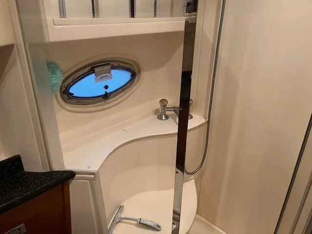 Slide: The Image of 2005 Carver 46 Motor Yacht bathroom with shower, porthole, and modern fixtures. - 30