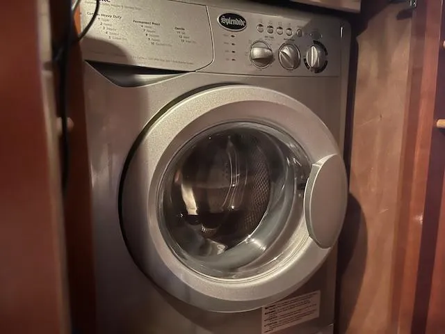 Slide: The Image of Washing machine inside 2005 Carver 46 Motor Yacht, compact and efficient design. - 32