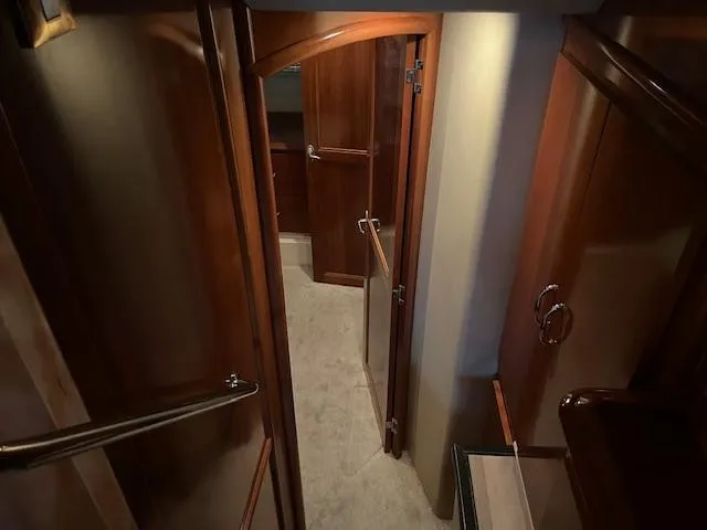 Slide: The Image of Interior hallway of 2005 Carver 46 Motor Yacht with wooden doors and carpeted floor. - 33