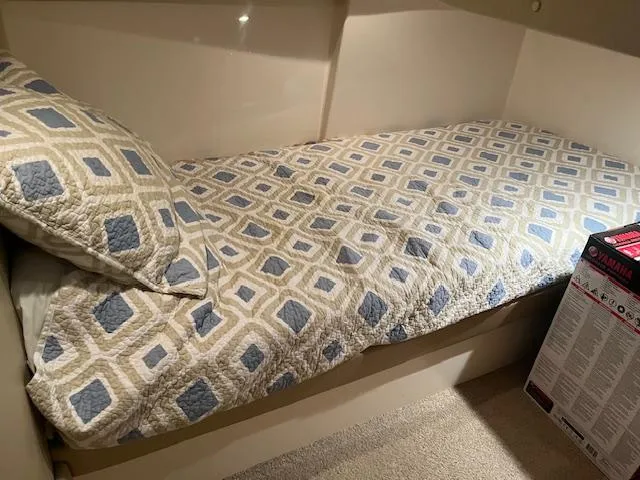 Slide: The Image of 2005 Carver 46 Motor Yacht cabin with patterned bedding and cozy interior. - 34