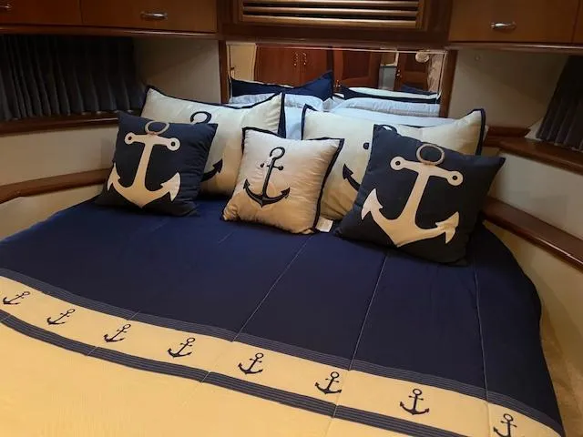 Slide: The Image of Nautical-themed bedroom in 2005 Carver 46 Motor Yacht with anchor pillows and bedding. - 36