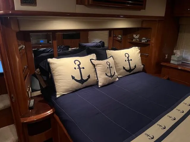 Slide: The Image of Luxurious bedroom interior of 2005 Carver 46 Motor Yacht with nautical-themed bedding. - 37