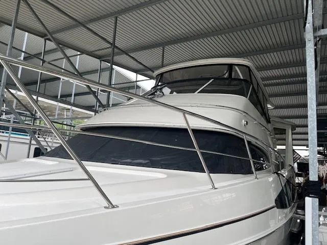 Slide: The Image of 2005 Carver 46 Motor Yacht docked under a metal canopy. - 4