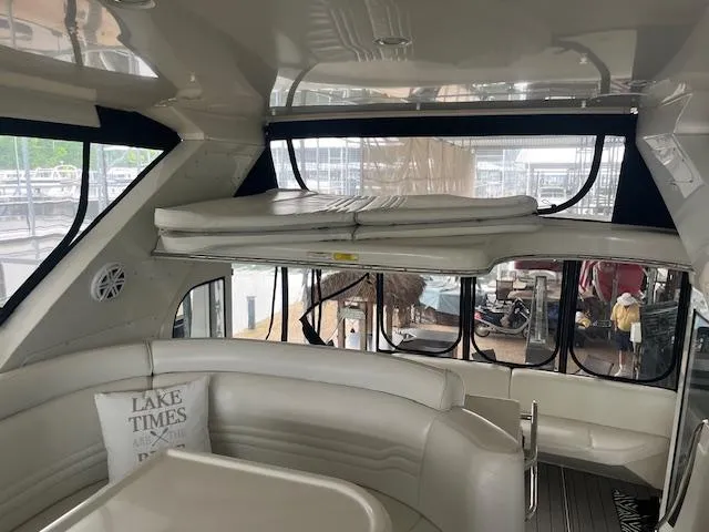 Slide: The Image of Interior of 2005 Carver 46 Motor Yacht with white seating and large windows. - 40