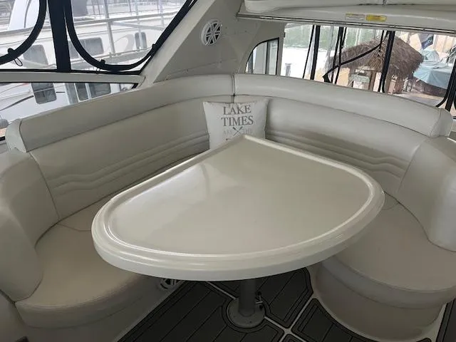 Slide: The Image of 2005 Carver 46 Motor Yacht interior with white seating and table, featuring "Lake Times" pillow. - 41