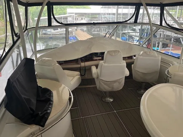 Slide: The Image of 2005 Carver 46 Motor Yacht interior with helm and seating area, docked at marina. - 42