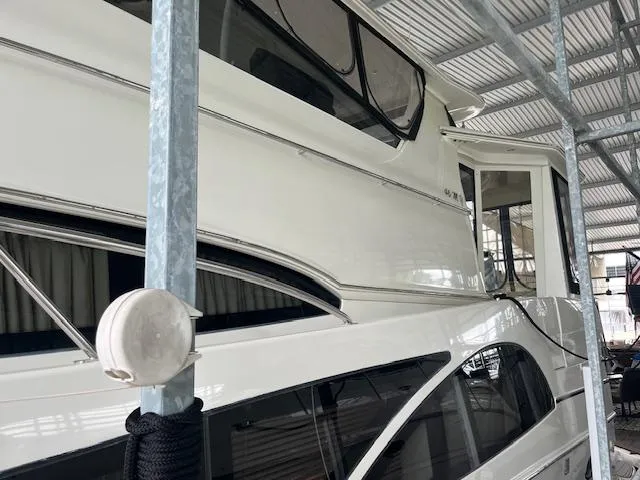 Slide: The Image of 2005 Carver 46 Motor Yacht docked under a metal canopy. - 5