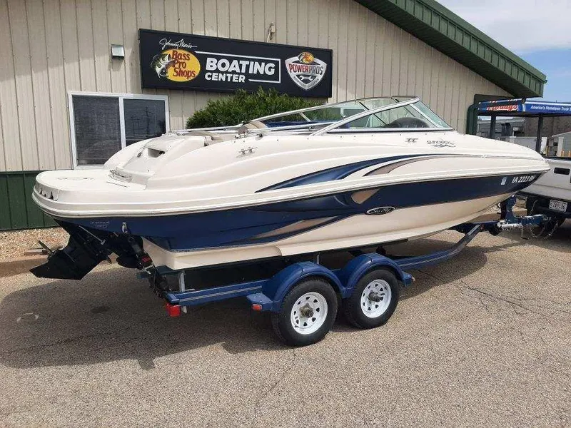 Slide: The Image of 2004 Sea Ray SunDeck 200 boat on trailer at a boating center. - 3