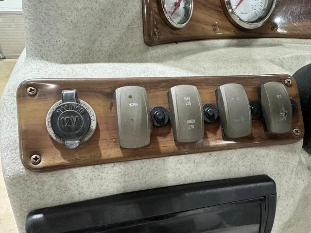 Slide: The Image of Control panel of a 2007 Premier 2023 Island Leisure boat with switches and 12V outlet. - 10