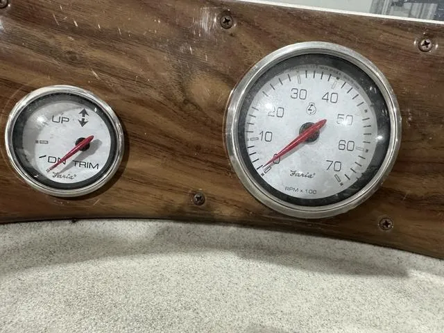 Slide: The Image of Dashboard gauges of a 2007 Premier 2023 Island Leisure boat, featuring trim and RPM indicators. - 11