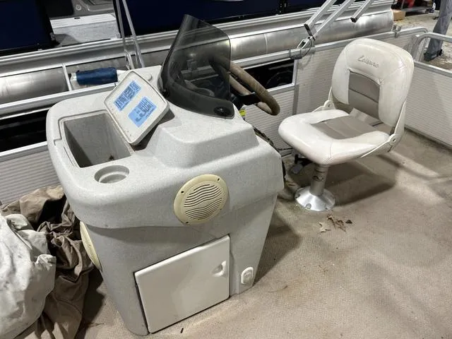 Slide: The Image of Captain's chair and console of a 2007 Premier 2023 Island Leisure boat. - 13
