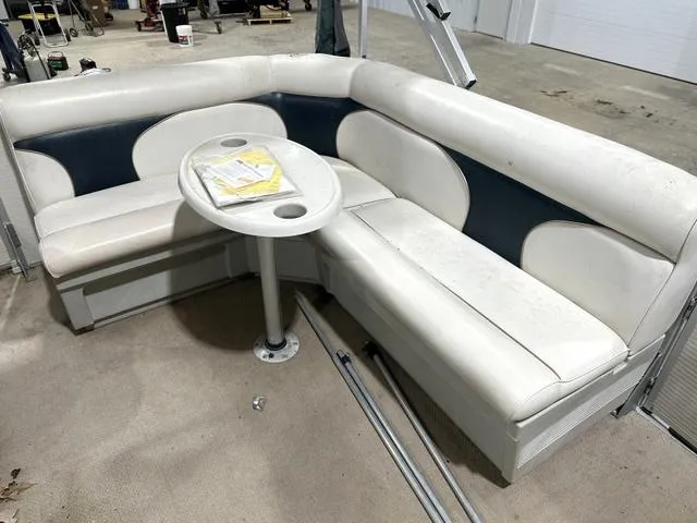Slide: The Image of White and blue seating area with table on 2023 Premier Island Leisure boat. - 14