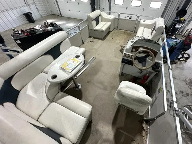 Slide: The Image of Interior of a 2007 Premier 2023 Island Leisure pontoon boat in a garage setting. - 16