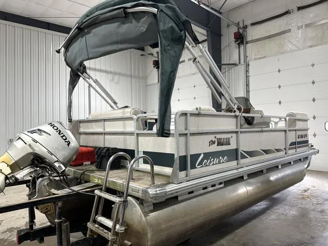 Slide: The Image of Pontoon boat in garage, Premier 2023 Island Leisure model, with Honda outboard motor. - 4