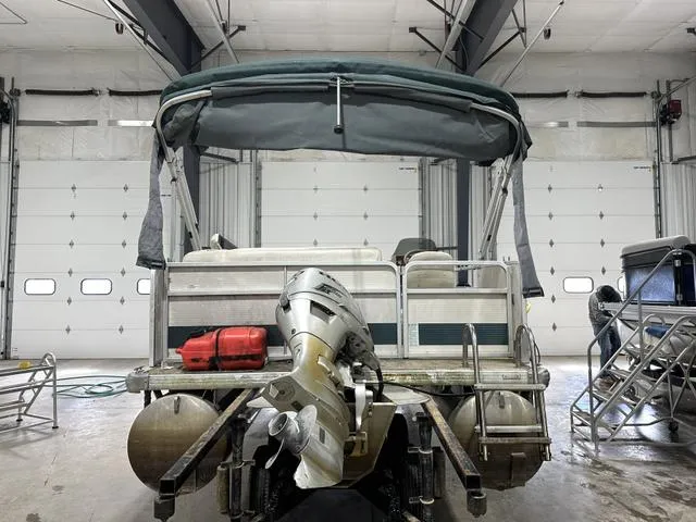 Slide: The Image of Pontoon boat in garage, Premier 2023 Island Leisure, rear view with outboard motor. - 5