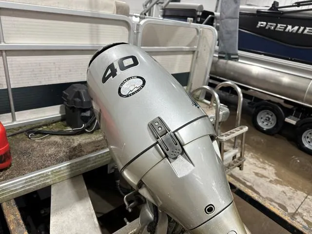 Slide: The Image of Outboard motor on a Premier 2023 ISLAND LEISURE boat, showcasing a 40 horsepower engine. - 6