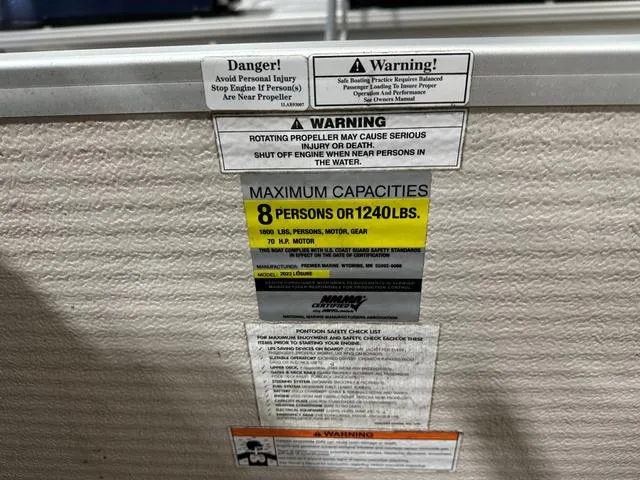 Slide: The Image of Warning labels on Premier 2023 ISLAND LEISURE boat, maximum capacity 8 persons or 1240 lbs. - 8