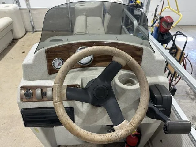 Slide: The Image of Steering console of a 2007 Premier 2023 Island Leisure boat in a garage setting. - 9