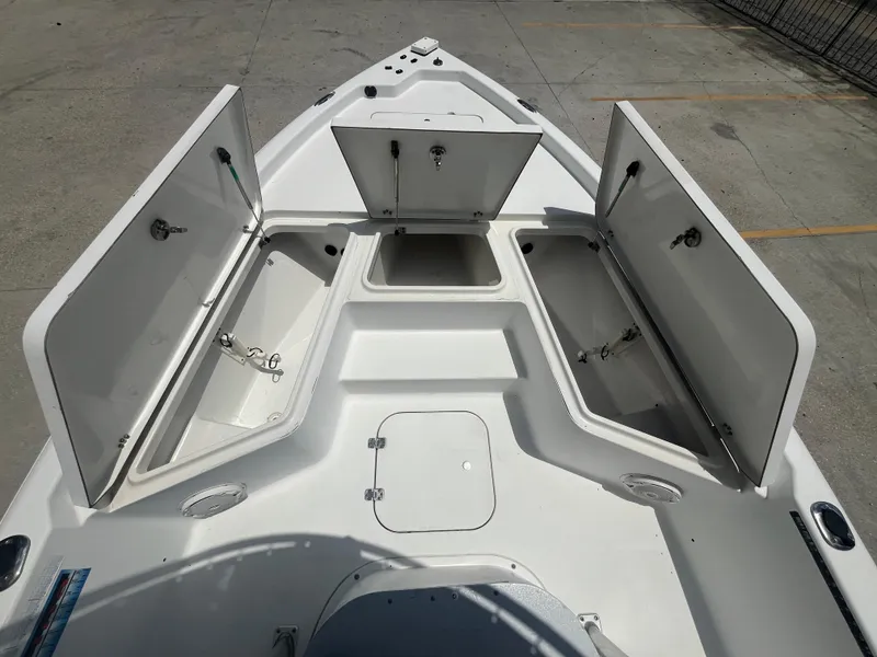 Slide: The Image of 2010 Sea Hunt 21 XP boat with open storage compartments on deck. - 11