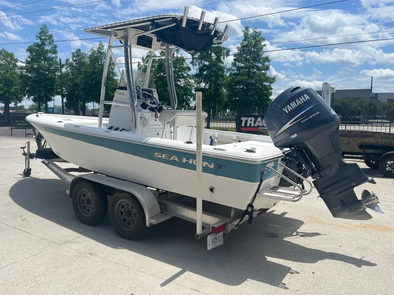 Slide: The Image of 2010 Sea Hunt 21 XP boat on trailer with Yamaha outboard motor, parked outdoors. - 5