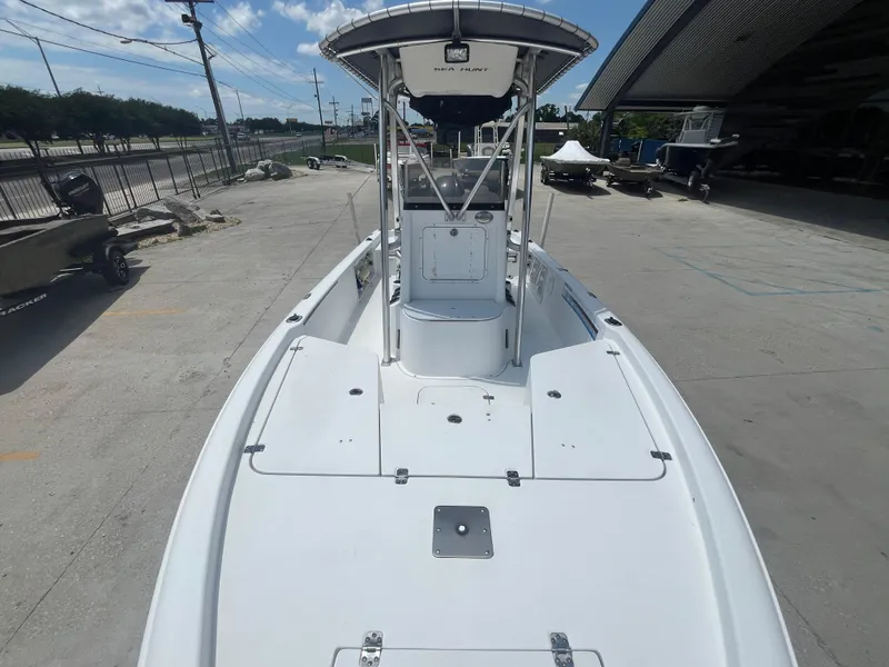 Slide: The Image of 2010 Sea Hunt 21 XP boat on concrete lot under blue sky. - 9