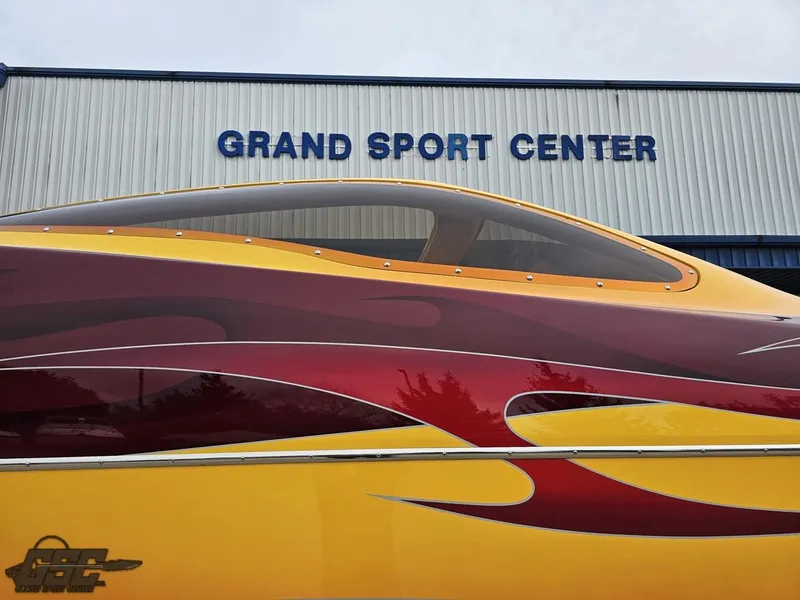 Slide: The Image of 2008 Eliminator 36 Daytona Coupe at Grand Sport Center, featuring vibrant red and yellow design. - 11