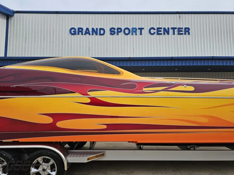 Slide: The Image of 2008 Eliminator 36 Daytona Coupe with vibrant flame design at Grand Sport Center. - 13