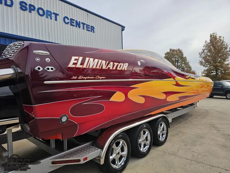Slide: The Image of 2008 Eliminator 36 Daytona Coupe boat with vibrant flame design on trailer. - 15