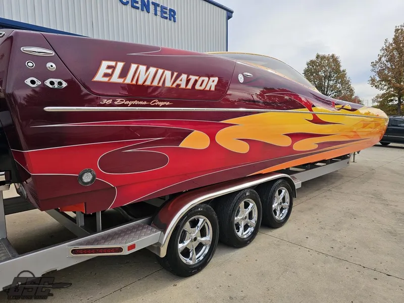 Slide: The Image of 2008 Eliminator 36 Daytona Coupe boat with vibrant flame design on trailer. - 17