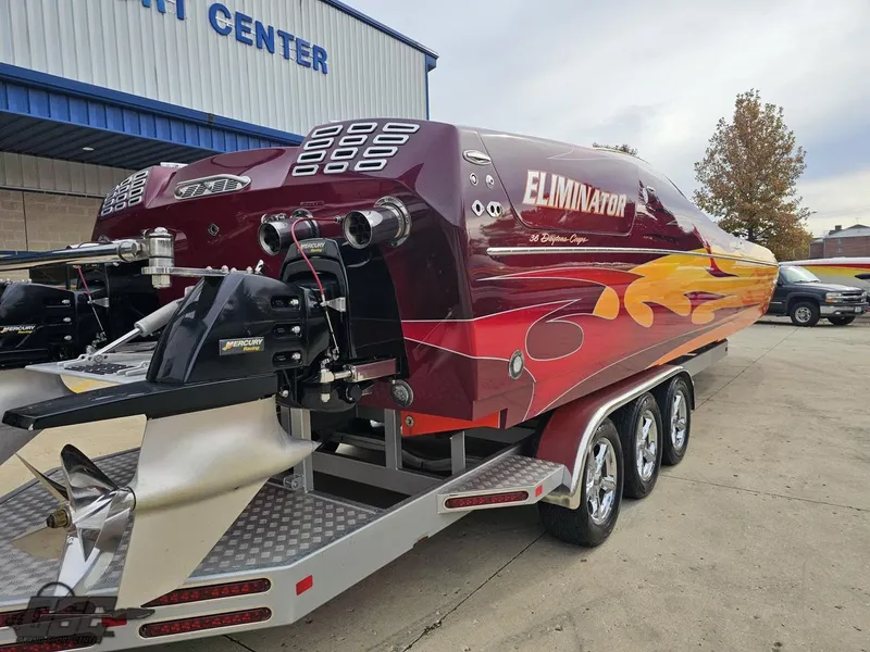 Slide: The Image of 2008 Eliminator 36 Daytona Coupe speedboat with vibrant flame design on trailer. - 18