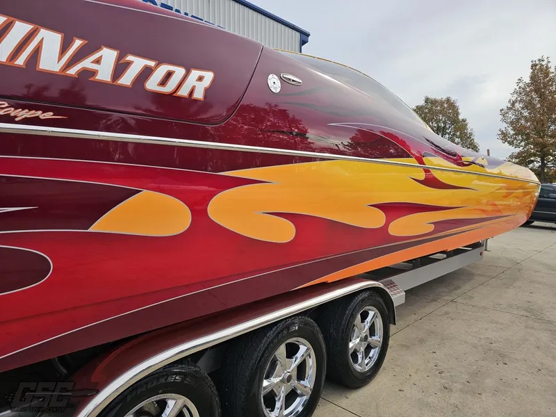 Slide: The Image of 2008 Eliminator 36 Daytona Coupe with vibrant flame design on trailer. - 19
