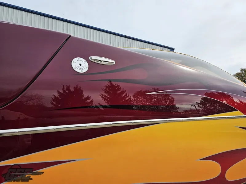 Slide: The Image of 2008 Eliminator 36 Daytona Coupe with vibrant red and yellow flame design. - 20