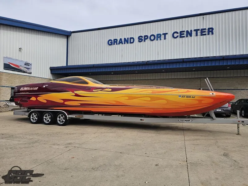 Slide: The Image of 2008 Eliminator 36 Daytona Coupe boat with vibrant flame design at Grand Sport Center. - 25