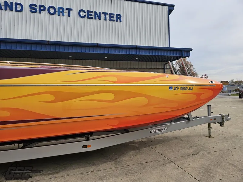 Slide: The Image of 2008 Eliminator 36 Daytona Coupe boat with vibrant flame design on trailer. - 26
