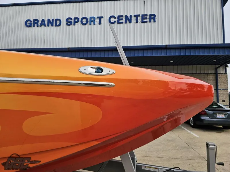 Slide: The Image of 2008 Eliminator 36 Daytona Coupe boat at Grand Sport Center, vibrant orange design. - 27
