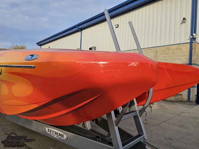 Slide: The Image of 2008 Eliminator 36 Daytona Coupe boat with vibrant orange design on trailer. - 29