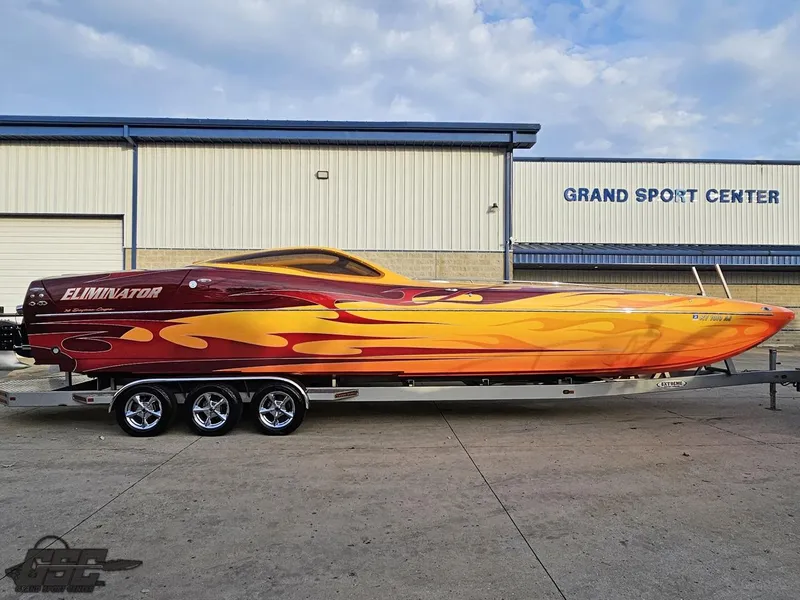 Slide: The Image of 2008 Eliminator 36 Daytona Coupe with vibrant flame design at Grand Sport Center. - 3